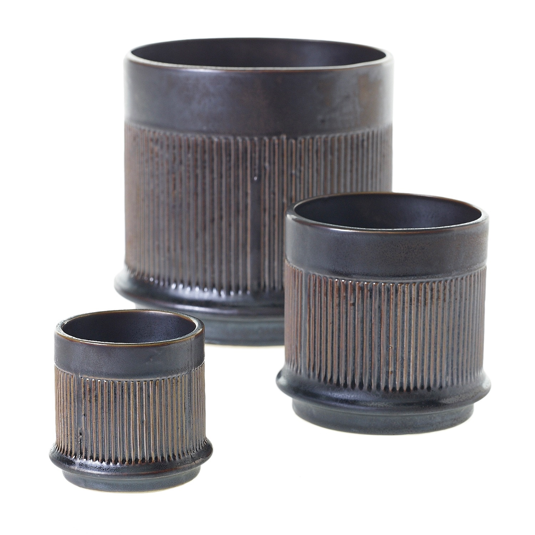 Westcott pots in dark metallic glaze with vertical ribbed bands, three sizes grouped