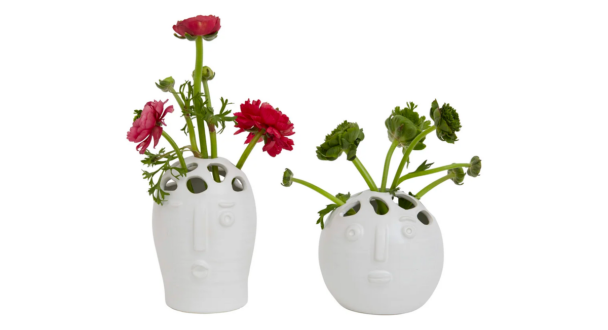 Both Picasso bud vases holding stems, red ranunculus in the tall one and green blooms in the round one