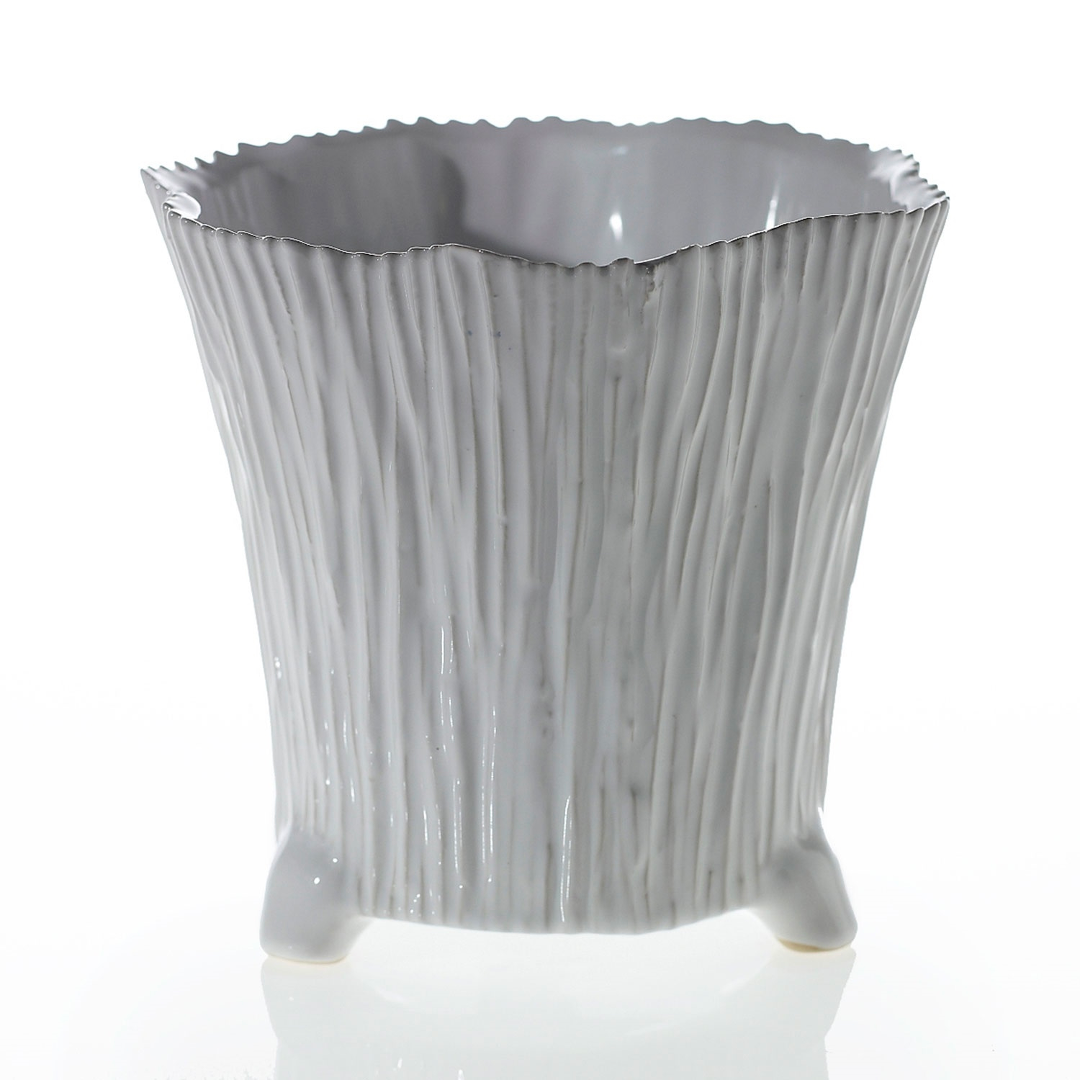 Wide Mellie pot with fine bark-like ribbing, a jagged rim, and short rounded feet