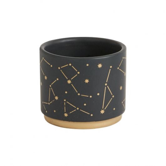 Black pot with star constellation in gold.